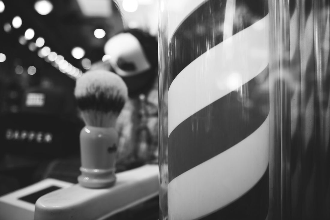 A classic red, white and blue barber pole spinning outside a shop