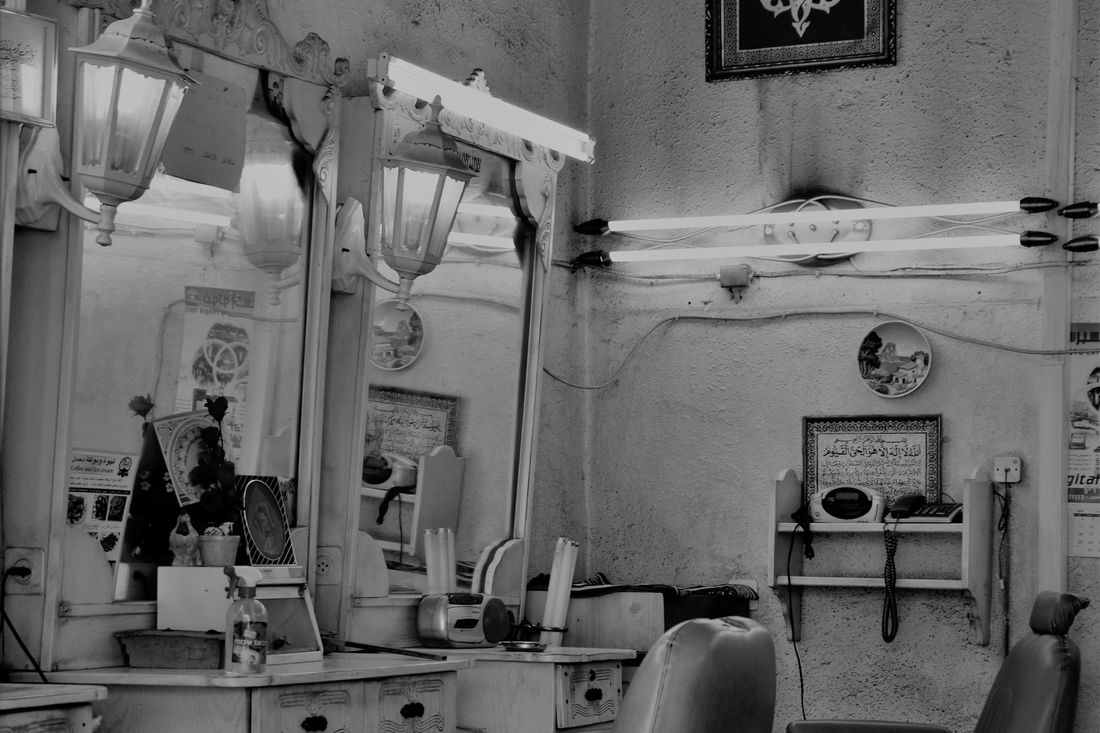 A vintage barbershop with a row of classic chairs and mirrors