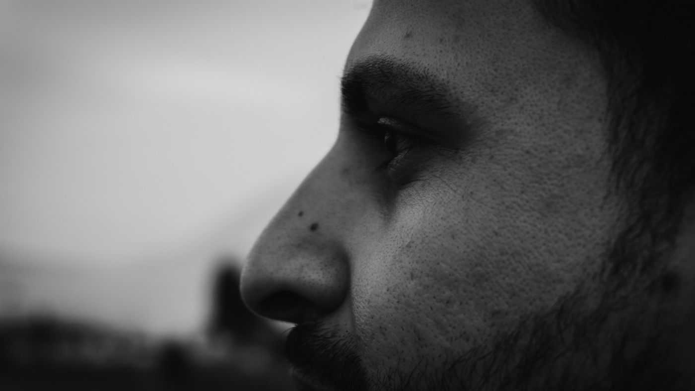 Close-up profile of a man with a short, dark beard