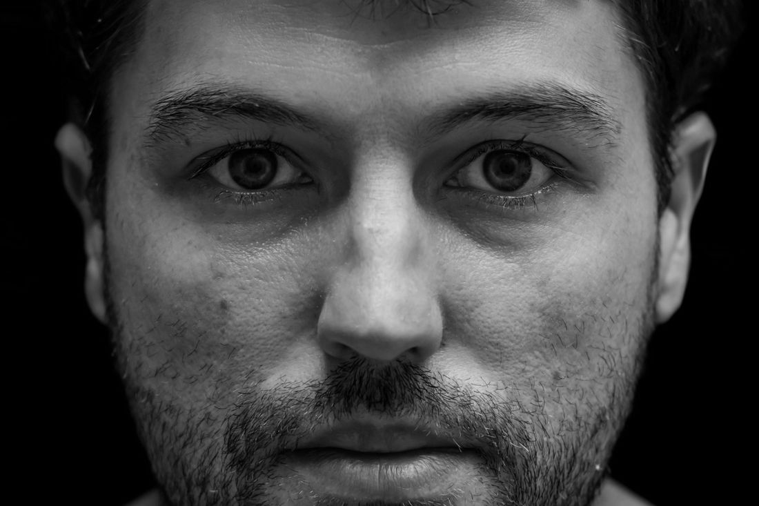 A man with a short beard looking straight at the camera