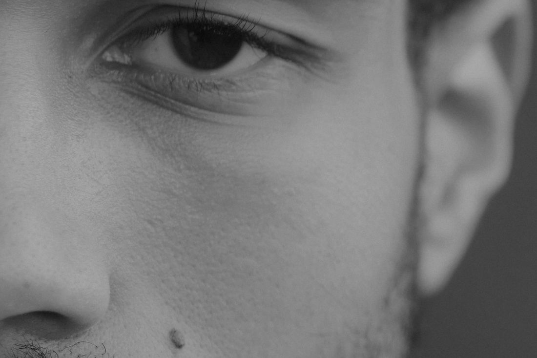 Close-up of a man's face with short, dark stubble