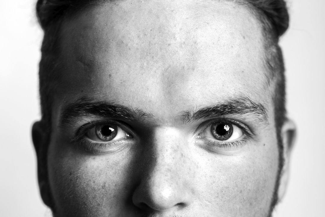Close-up of a man's eyes and forehead under short hair