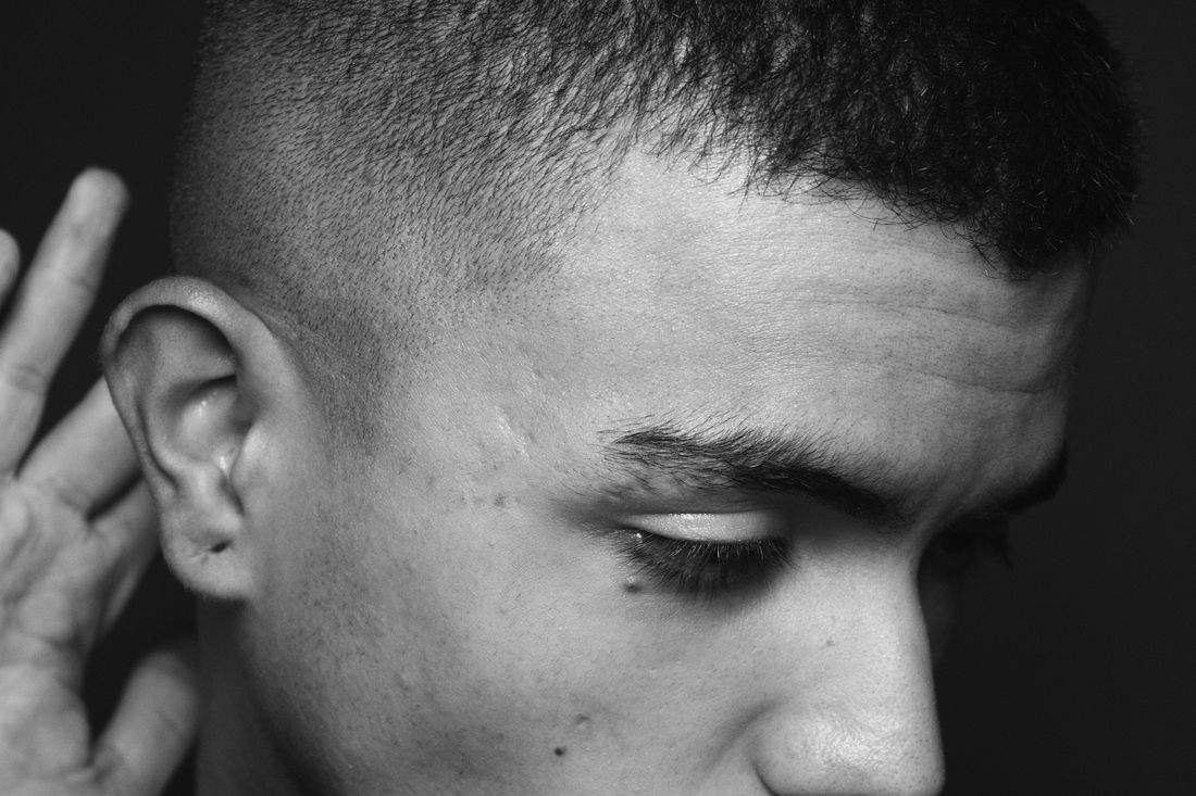 A young man with very short cropped hair and close-cut sides