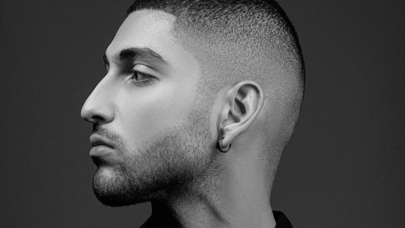 Profile of a man with very short faded sides and a short beard
