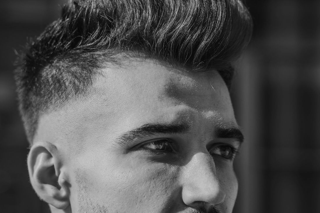 Close-up of a man with short, tousled, slightly wavy hair