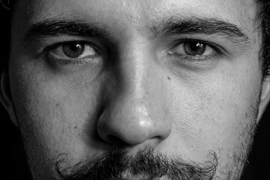 Close-up of a man's face with a short mustache