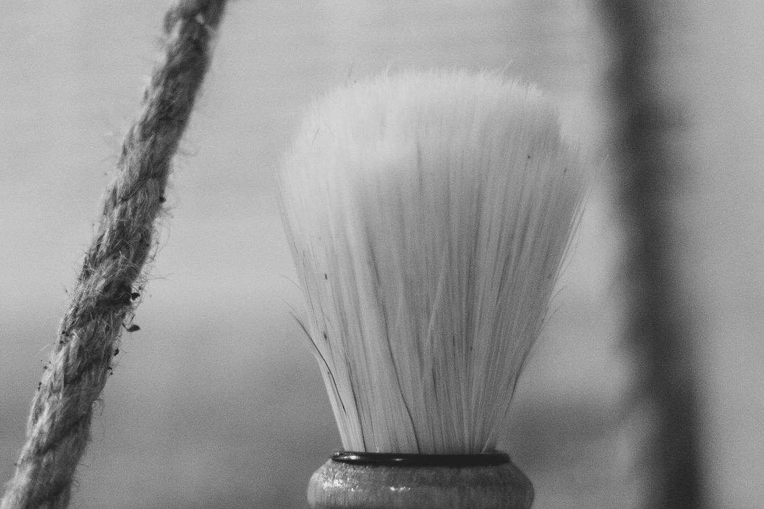 A shaving brush standing upright, close up