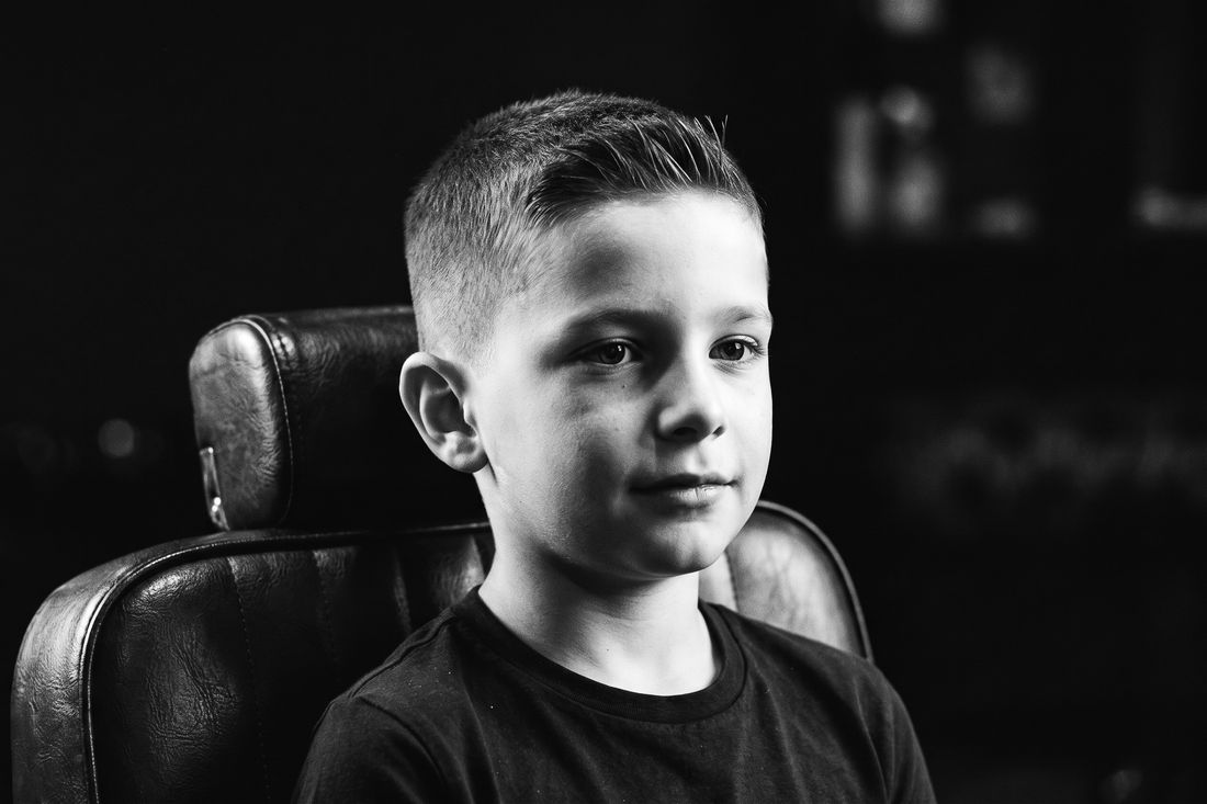 A boy with a short crew cut, a little extra length at the front