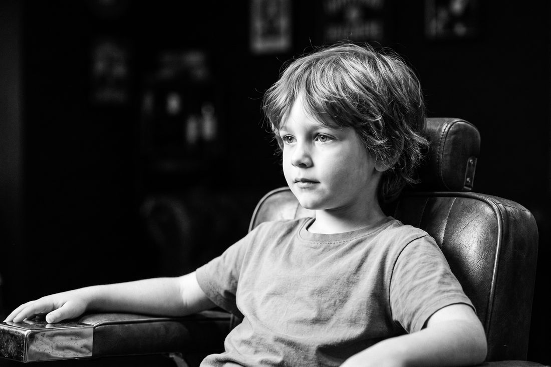 A boy with a soft scissor cut, longer unstructured sides and no clipper work