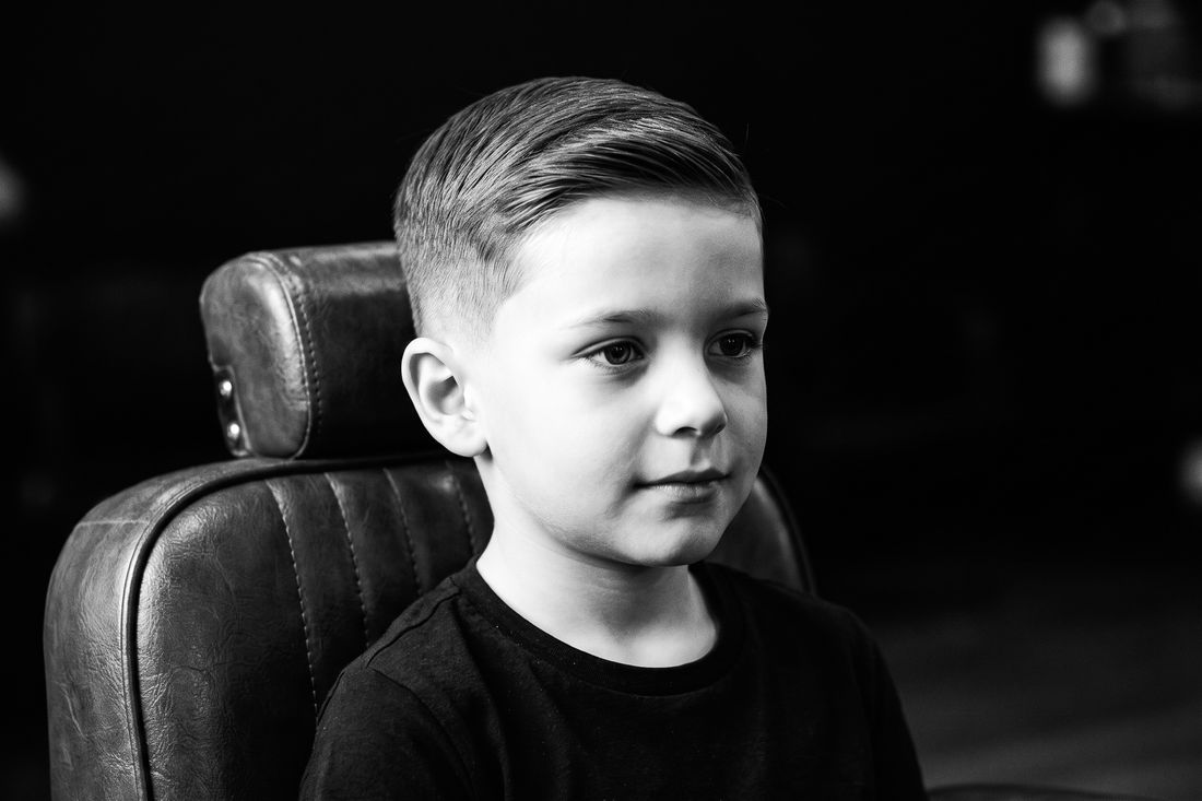 A boy with a neat classic taper haircut, short at the sides and longer on top