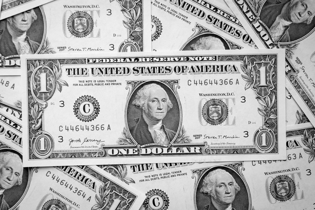 A loose pile of one-dollar bills